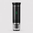Tazzi portable espresso maker in matte black, front view, assembled with the ribbed clear cup attached