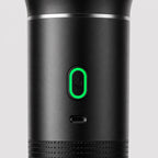 Close-up of the Tazzi single pill-shaped button with green LED ring and the USB-C charging port below it