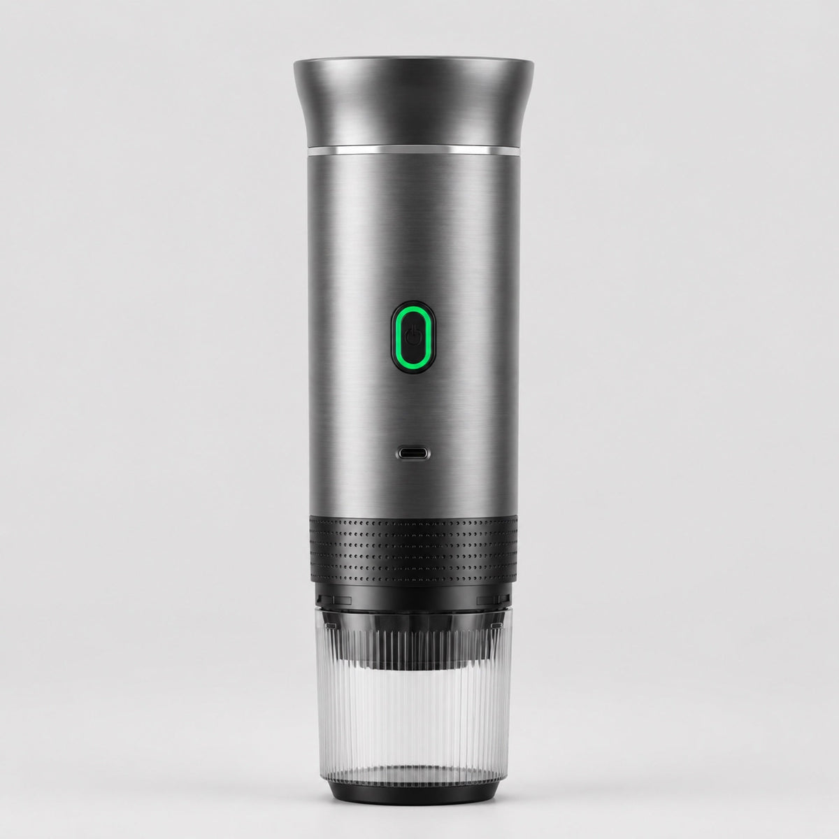 Tazzi portable espresso maker in brushed metal, front view, assembled with the ribbed clear cup attached